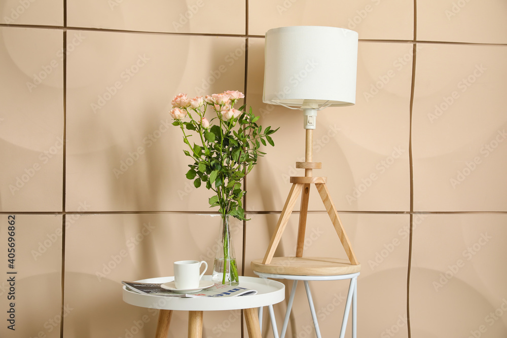 Tables with decor near color wall