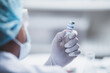 © chokniti - fight against COVID-19, coronavirus vaccine research in hospital laboratory, professional scientists holds bottle of new vaccine for virus cure treatment injection, medicine clinical during pandemic