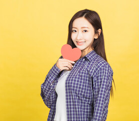 smiling young woman  holding in hands  small little heart