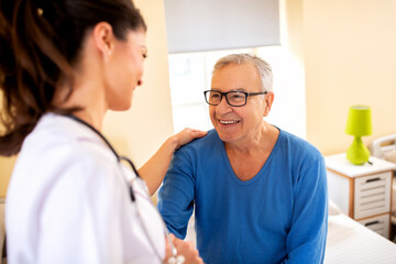 Nursing home doctor providing care to a senior man resident