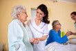 © didesign - Senior man and senior woman nursing home residents assisted by medical staff of the residential facility
