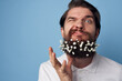 © SHOTPRIME STUDIO - Cheerful man flowers in a beard lifestyle emotions close-up