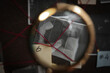 © New Africa - Looking at detective board through magnifying glass, closeup