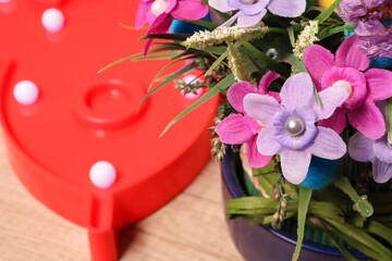 Red lamp and artificial bouquet of flowers.