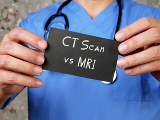 Conceptual photo about CT Scan vs MRI with written phrase.