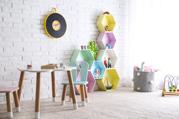 Sticker - Child room interior with colorful shelves near brick wall