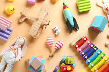 Different Toys On Beige Background, Flat Lay