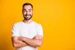 © deagreez - Portrait of attractive cheerful bearded curious guy folded arms copy space thinking isolated over bright yellow color background