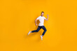 © deagreez - Full length body size photo of jumping man wearing casual clothes isolated bright yellow color background