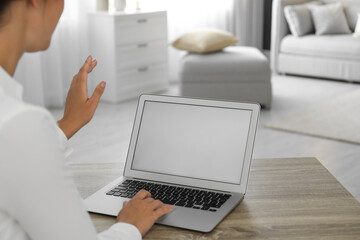 Wall Mural - Coworkers working together online. Young woman using video chat on laptop, closeup