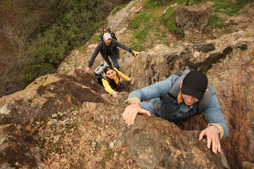 Wall Mural - Group of hikers with backpacks climbing up mountains, above view