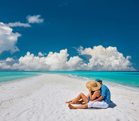 Wall Mural - Couple in blue on a beach at Maldives