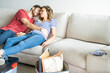 © PhotoAlto - Young couple sleeping on sofa in their new house