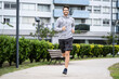© PhotoAlto - Young man jogging in park
