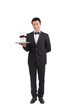 © eastfenceimage - A Asian waiter holding tray of champagne