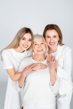 Three Generation Of Happy Women Smiling While Looking At Camera Isolated On Grey