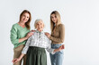 © LIGHTFIELD STUDIOS - three generation of pleased women looking at camera isolated on white