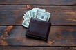 Male wallet with banknotes. Leather wallet with dollar bills.