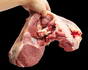 Sticker - Fresh beef meat in hand isolated on black background.