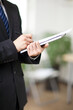 © eastfenceimage - Portrait of young businessman writing in office,close-up