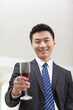 © eastfenceimage - Portrait of businessman holding a glass of wine