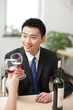 © eastfenceimage - Portrait of businessman holding a glass of wine and toasting
