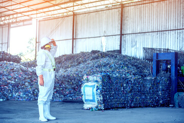 Wall Mural - Waste processing plant. Technological process plastic bottles at the factory for processing and recycling. The worker recycling factory,engineers is out of focus or blurred.