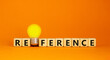 Reference symbol. Wooden cubes with the word 'reference'. Yellow light bulb. Beautiful orange background. Business and reference concept. Copy space.
