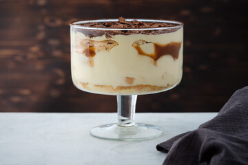 Wall Mural - Tiramisu with caramel in a large glass.