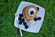 Whole grain pancakes with blackberries, cottage cheese on white plate