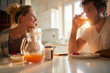 © luckybusiness - A young couple in love relaxing at the table after breakfast at home. Relationship, love, together, breakfast