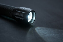 Flashlight With Beam Of Light Close Up On Black Background