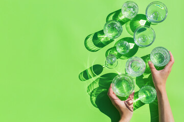 Sticker - Water glasses on a green background, trendy light and shadow