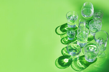 Sticker - Water glasses on a green background, trendy light and shadow