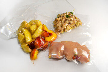 Wall Mural - Chicken breast, peach slices and champignon mushrooms  vacuum packed sealed for sous vide cooking on white background