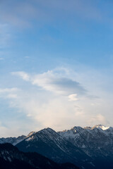 Wall Mural - Mountain range around the Schwarzhanskarspitze mountain in vertical format in winter with gentle soft clouds and blue sky