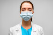 © fotofabrika - Portrait of a young woman doctor or medical worker wearing mask