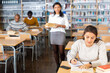 © JackF - Adult female student working in library, concept of adult education