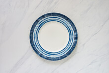 Empty Plate With Blue Round Design On Marble Tabletop, Food Background Lay Flat Image