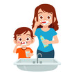 happy cute kid boy brush teeth with mom