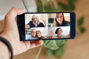 Multigeneration people having video call with mobile phone during lockdown isolation - Social distance concept