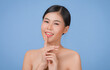 © NITIKAN T. - Beauty Spa Woman with perfect skin Portrait. Asian beautiful woman skin makeup young model, on blue studio