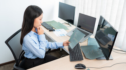asian woman programming working with computer and typing data code to developing program at table in