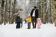 © alexkich - Happy family playing and laughing in winter outdoors in the snow. City park winter day.