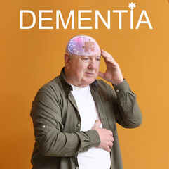 Wall Mural - Elderly man suffering from mental disability on color background