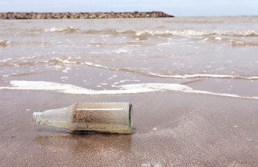 Sand and stone in Old bottle on the beach.