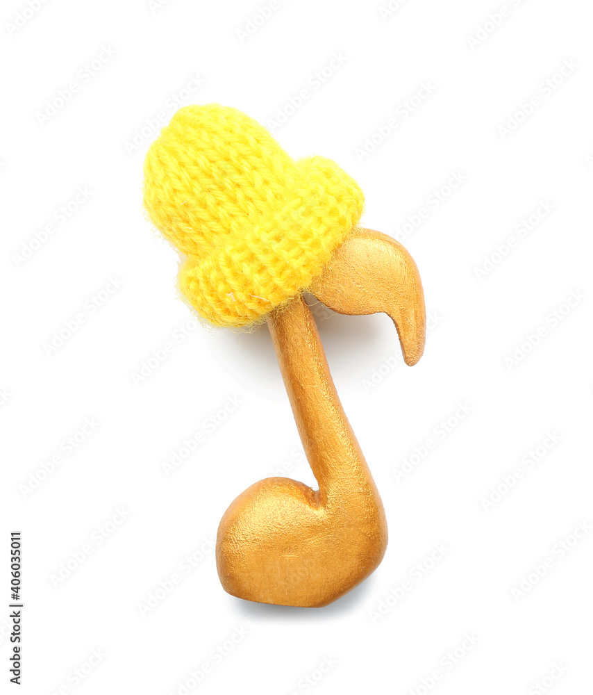 Golden music note with knitted hat isolated on white background