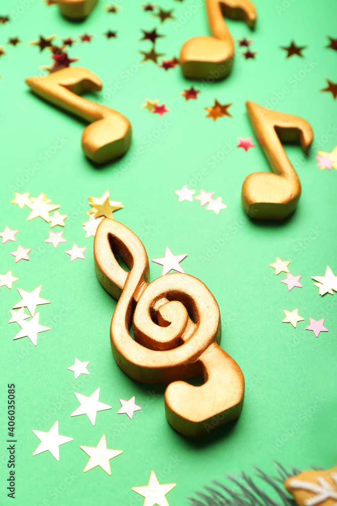 Music notes with Christmas decor on color background