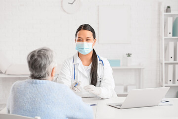 Senior woman visiting doctor in clinic