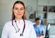 © JackF - Portrait of smiling young female doctor meeting patient in medical office